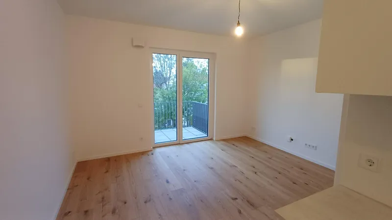 Erstbezug: Moderne 1-Zimmer-Neubauwohnung mit Balkon ins Grüne, EBK & Parkett – A+ — photo 1